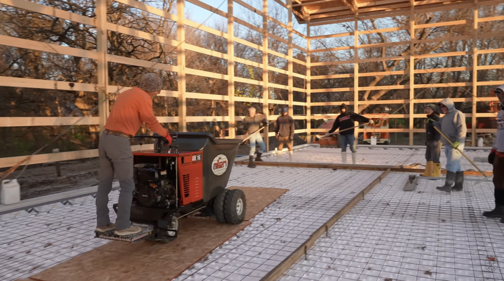 Since a concrete truck or pump couldn’t access the interior, the crew carted the mix in by buggy to pour the radiant-heated shop floor.